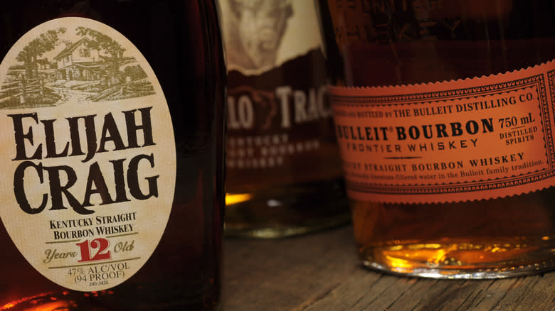 Various bourbon bottles on wood