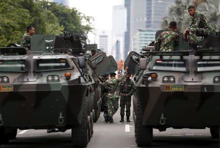 Military armoured personnel carriers are seen near the site of an attack in central Jakarta January 14, 2016. REUTERS/Darren Whiteside