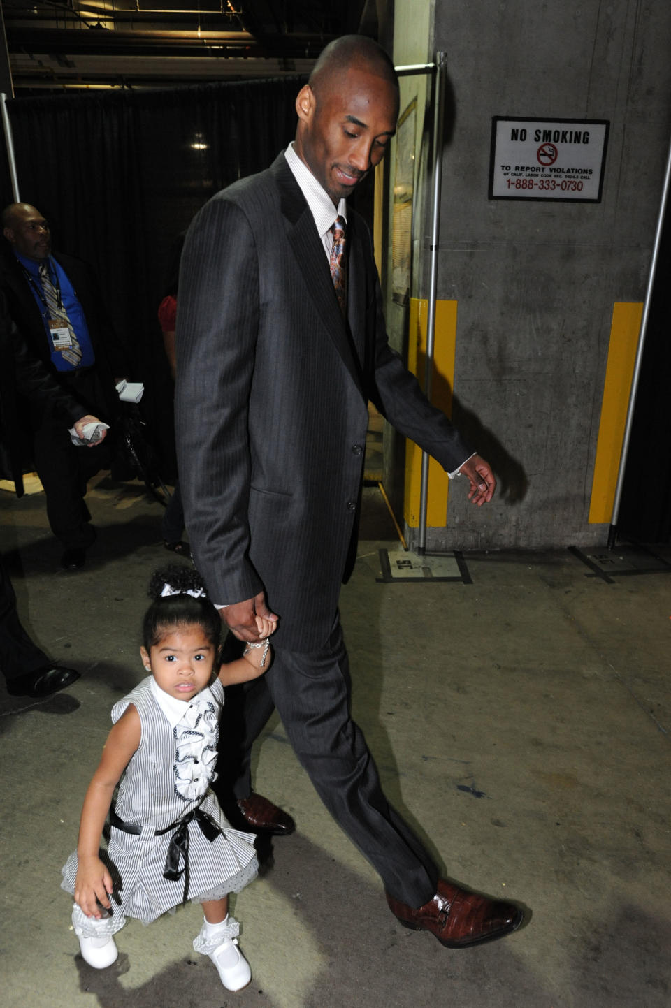 Kobe Bryant #24 of the Los Angeles Lakers walks out of the arena with daughter Gianna following his team's victory over the Boston Celtics in Game Five of the 2008 NBA Finals at Staples Center June 15, 2008 in Los Angeles, California. (Photo by Andrew D. Bernstein/NBAE via Getty Images)