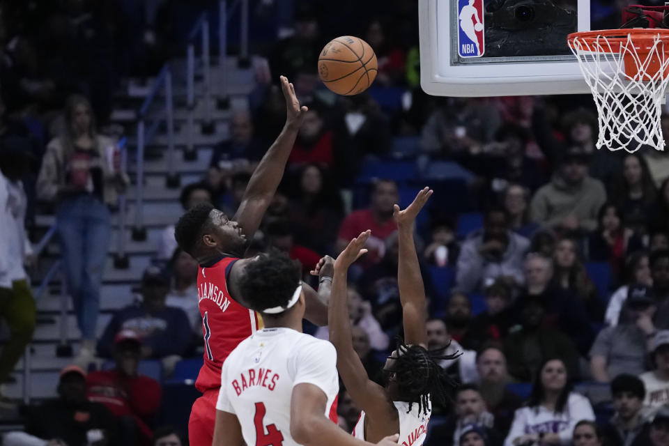 New Orleans Pelicans forward Zion Williamson (1) shoots over Toronto Raptors guard Immanuel Quickley (5) in the first half of an NBA basketball game in New Orleans, Monday, Feb. 5, 2024. (AP Photo/Gerald Herbert)