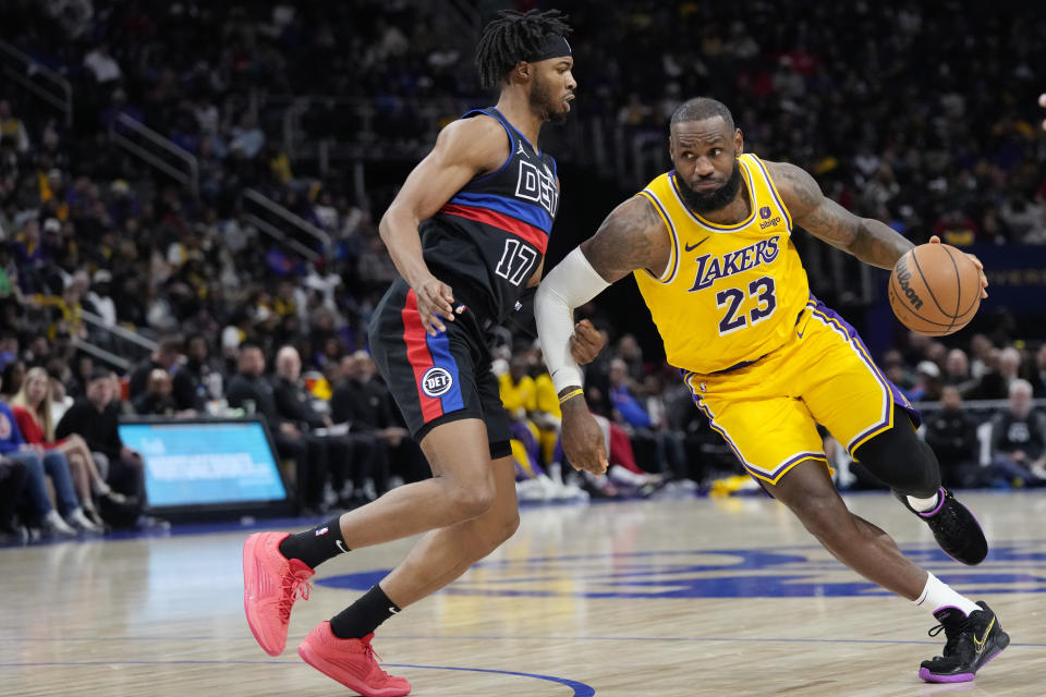 Los Angeles Lakers forward LeBron James (23) drives on Detroit Pistons guard Stanley Umude (17) during the second half of an NBA basketball game, Wednesday, Nov. 29, 2023, in Detroit. (AP Photo/Carlos Osorio)