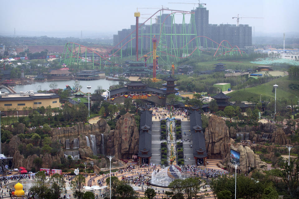 <p>Visitors make their way toward the Nanchang Wanda Park theme park during its grand opening day in Nanchang in southeastern China’s Jiangxi province, May 28, 2016. China’s largest private property developer, the Wanda Group, opened an entertainment complex on Saturday that it’s positioning as a distinctly homegrown rival to Disney and its $5.5 billion Shanghai theme park opening next month. (AP Photo/Mark Schiefelbein) </p>