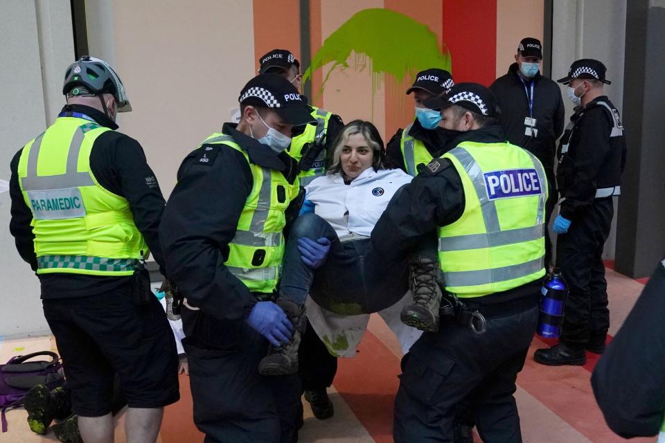 A protester is removed and arrested by police outside the Scottish Power building (PA)