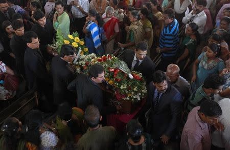 Jacintha Saldanha's family and relatives carry her coffin during her funeral inside a church in Shirva, about 52 kms (32 miles) north of Mangalore December 17, 2012. REUTERS/Danish Siddiqui/Files