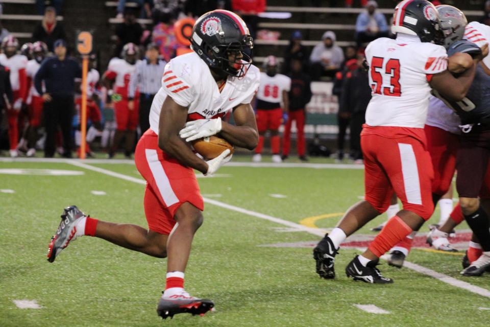 Aliquippa running back Tiqwai Hayes looks for room during Friday night's Battle for the Bridge in Ambridge.