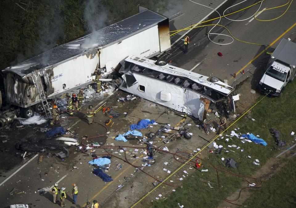 This Oct. 2, 2013 photo shows the scene of a fatal three-vehicle accident involving a church bus near Dandridge, Tenn. Investigators concluded, Monday, April 28, 2014, a blown tire caused the accident in which the bus crossed the Interstate 40 median and crash into an SUV and tractor-trailer, killing eight people and injuring 14. (AP Photo/Knoxville News Sentinel, Paul Efird)