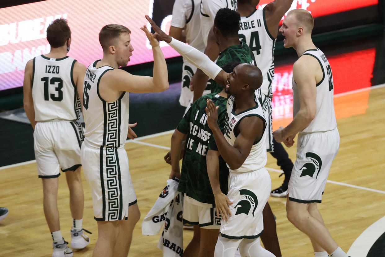 Joshua Langford of the Michigan State Spartans celebrates a 70-64 win over the Michigan Wolverines with teammates at the Breslin Center on March 07, 2021 in East Lansing, Michigan. (Photo by Gregory Shamus/Getty Images)