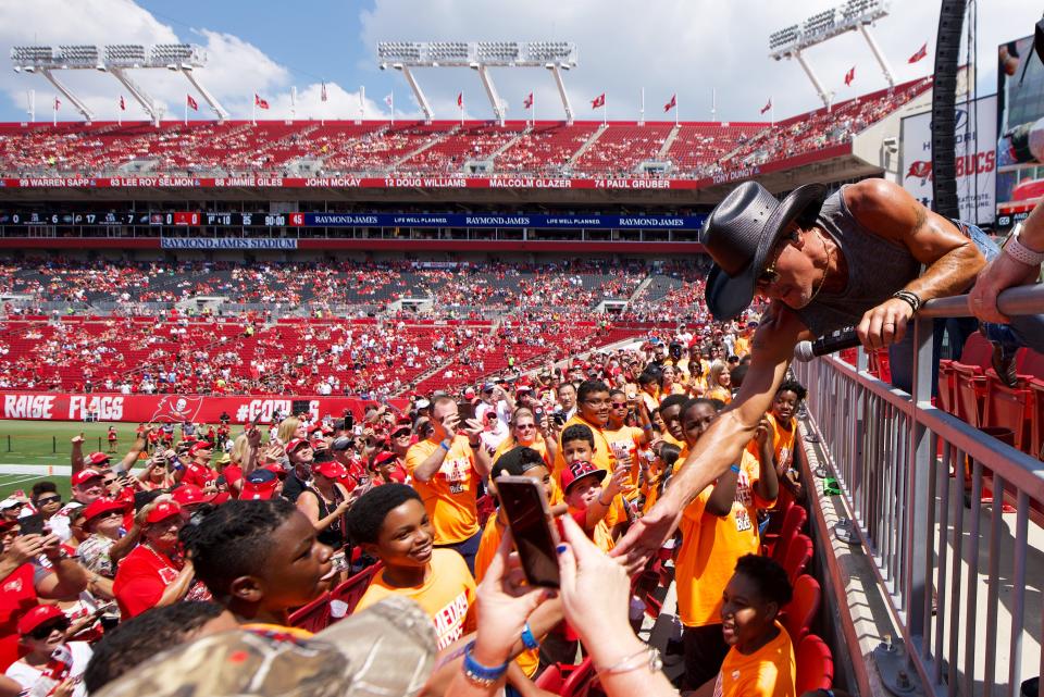 Tim McGraw reaches out to fans during a pregame performance before the NFL season kicks off between the Tampa Bay Buccaneers and the San Francisco 49ers at Raymond James Stadium on September 8, 2019 in Tampa, Florida. 