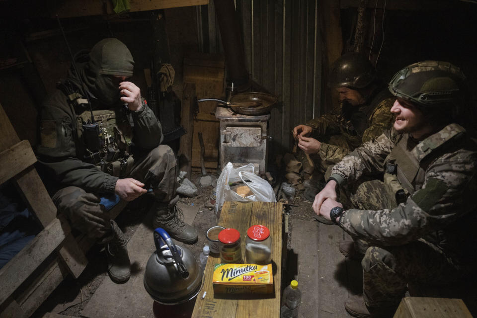 FILE - Ukrainian soldiers of the 71st Jaeger Brigade chat in a shelter at the frontline, near Avdiivka, Donetsk region, Ukraine, Friday, March 22, 2024. Approval by the U.S. House of a $61 billion package for Ukraine puts the country a step closer to getting an infusion of new firepower. But the clock is ticking. Russia is using all its might to achieve its most significant gains since the invasion by a May 9 deadline. (AP Photo/Efrem Lukatsky, File)