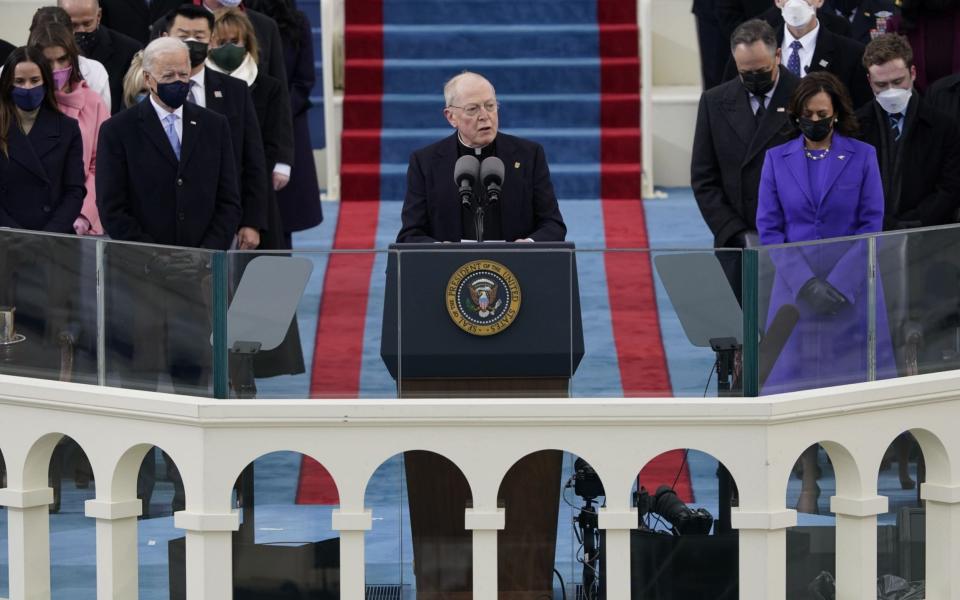 Father Leo O'Donovan delivers the invocation as President-elect Joe Biden, left, and Vice President-elect Kamala Harris look on during the inauguration of Joe Biden as US President in Washington, DC, USA, 20 January 2021. Biden won the 03 November 2020 election to become the 46th President of the United States of America - EPA