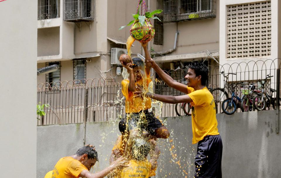 <p>A visually challenged child tries to break the Dahi handi an earthen pot filled with curd hung high, during celebrations to mark Janmashtami at the Victoria School for the Blind in Tardeo, on September 1, 2018 in Mumbai, India. (Photo by Bhushan Koyande/Hindustan Times via Getty Images) </p>