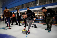 A refugee family from Afghanistan are introduced to the sport of curling at the Royal Canadian Curling Club during an event put on by the "Together Project", in Toronto, March 15, 2017. REUTERS/Mark Blinch