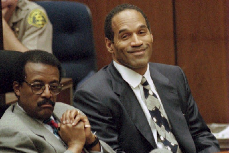 Lead defense attorney Johnnie Cochran (L) and defendant O.J. Simpson listen to testimony March 21, 1995. On June 17, 1994, Simpson led California Highway Patrol on a low-speed chase in his white Bronco. File Photo by Myung J. Chun/UPI