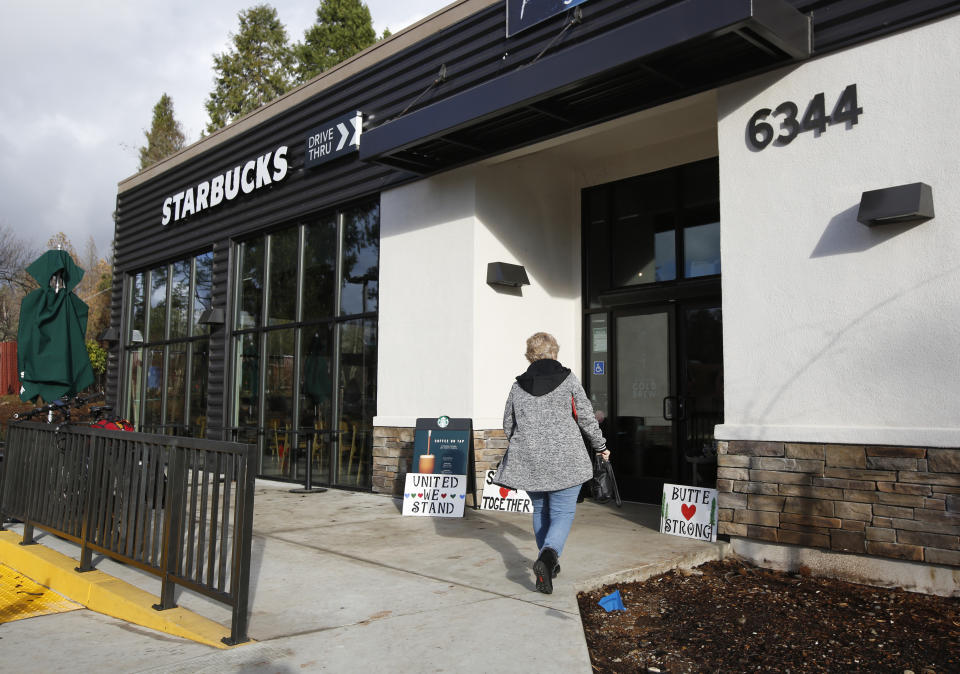 A customer walks into a Starbucks in Paradise, Calif., Thursday, Feb. 14, 2019. In the 100 days since the Camp Fire devastated the town, destroying the majority of businesses the ones that survived have begun to reopen. Starbucks, which reopened in January, has become a hub of activity for the few locals who didn't lose their homes and stayed. (AP Photo/Rich Pedroncelli)