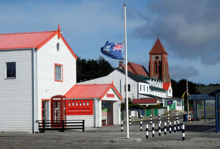 FILE PHOTO: The Falkland Islands flag flies at half mast in front of the Visitor Centre after the death of former British prime minister Margaret Thatcher, in Port Stanley, April 8, 2013. REUTERS/Gary Clement/File Photo