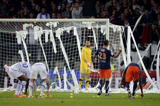 Auxerre's supporters throw tennis balls and toilet paper on the pitch during the French Ligue 1 match at the Abbe-Deschamps stadium in Auxerre. Montpellier claimed the first French league title in their history after winning the match 2-1