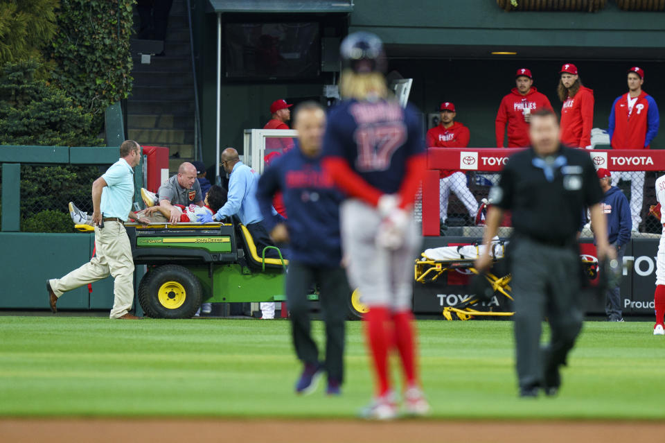 A fan, who fell into the Boston Red Sox bullpen, is carted off the field by medical staff during the first inning of a baseball game against the Philadelphia Phillies, Friday, May 5, 2023, in Philadelphia. (AP Photo/Chris Szagola)