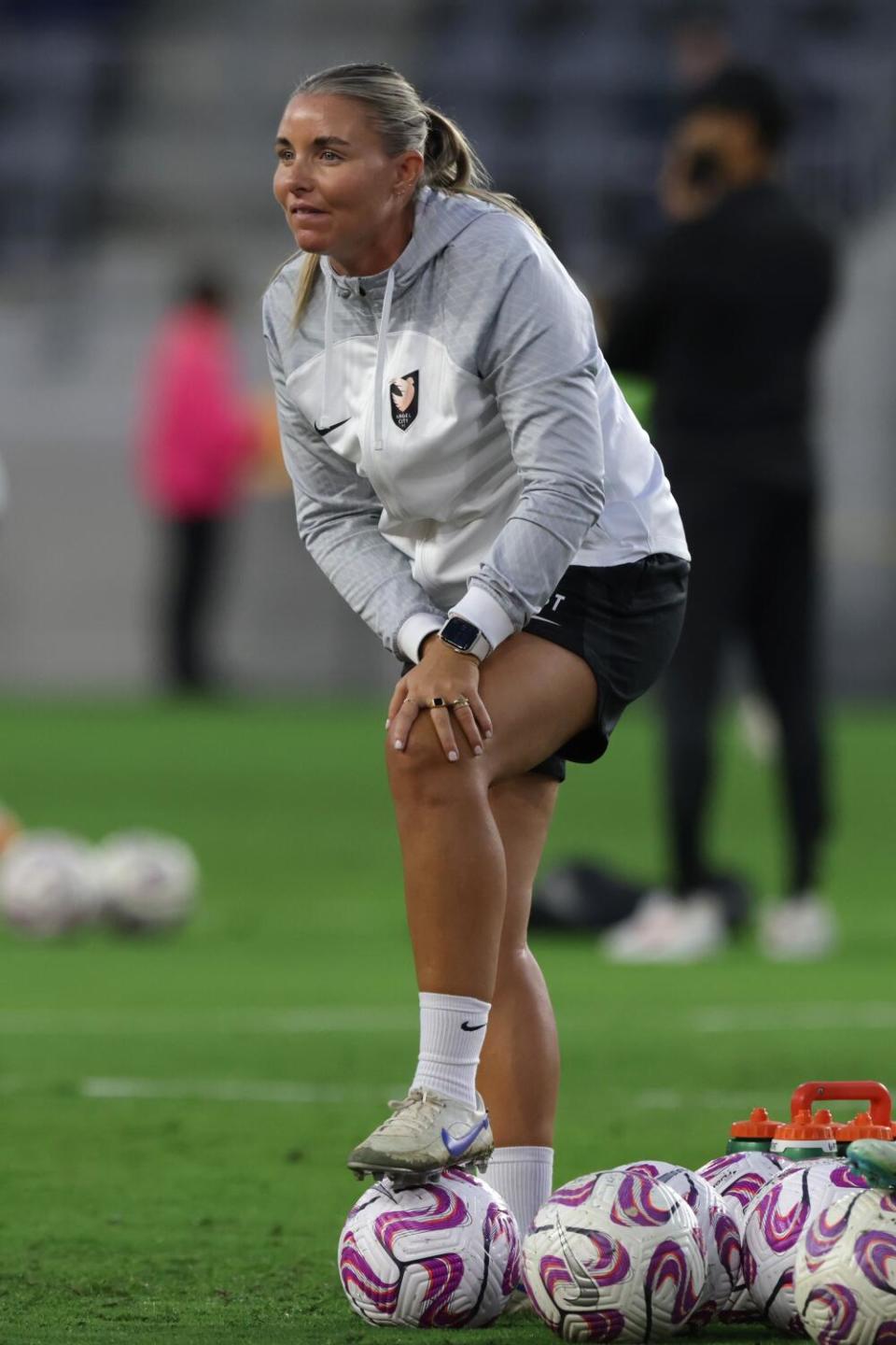 Angel City interim coach Becki Tweed watches players warm up before a match against the Orlando Pride at BMO Stadium.