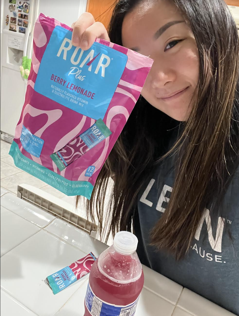 a woman posing with her drink powder