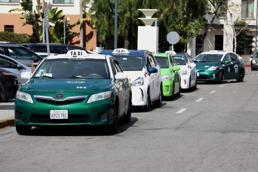LOS ANGELES, CA - FEBRUARY 15: Taxii cabs wait for fares at Los Angeles Union Station in downtown on Tuesday, Feb. 15, 2022 in Los Angeles, CA. The Los Angeles City Council is expected to vote Tuesday to overhaul a decades-old taxi permitting system and introduce ride hailing apps to compete with Uber and Lyft. (Gary Coronado / Los Angeles Times)