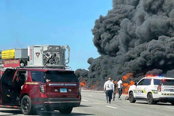 PHOTO: This photo provided by Angelique Feliciano shows firefighters and police responding after a crash involving a fuel truck and a car sparked a fire on the Gold Star Bridge between New London and Groton, Conn., on April 21, 2023. (Angelique Feliciano/AP)