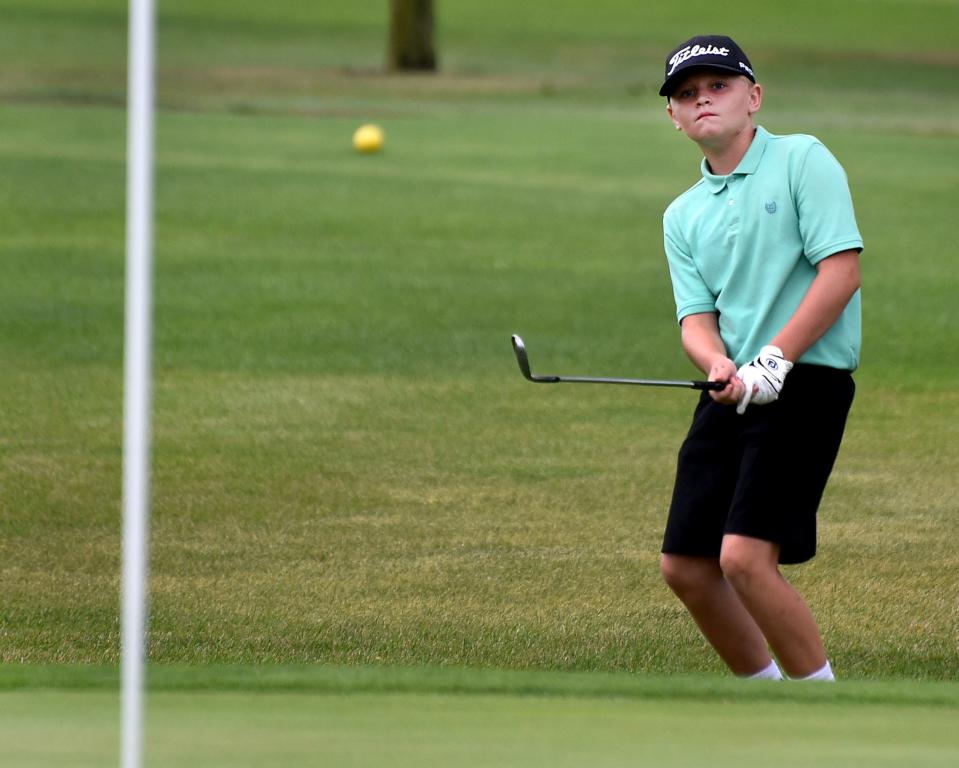 Levi Evans of Dundee chips to the flag during the 44th annual La-Z-Boy Junior Open at Green Meadows Wednesday.