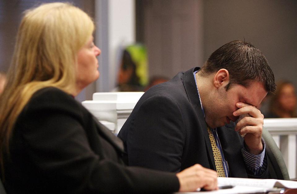 Army Sgt. Anthony Peden flanked by his attorney Melinda Ryals wipes tears from his eyes Thursday, May 1, 2014, in Ludowici, Ga., as he listens to an outline of the events of Dec 2011 when he shot and killed teenager Tiffany York in Long County, Ga. Peden was sentenced to life in prison Thursday by a southeast Georgia judge for the December 2011 slayings of 17-year-old Tiffany York and her boyfriend, former soldier Michael Roark. (AP Photo/Lewis Levine)