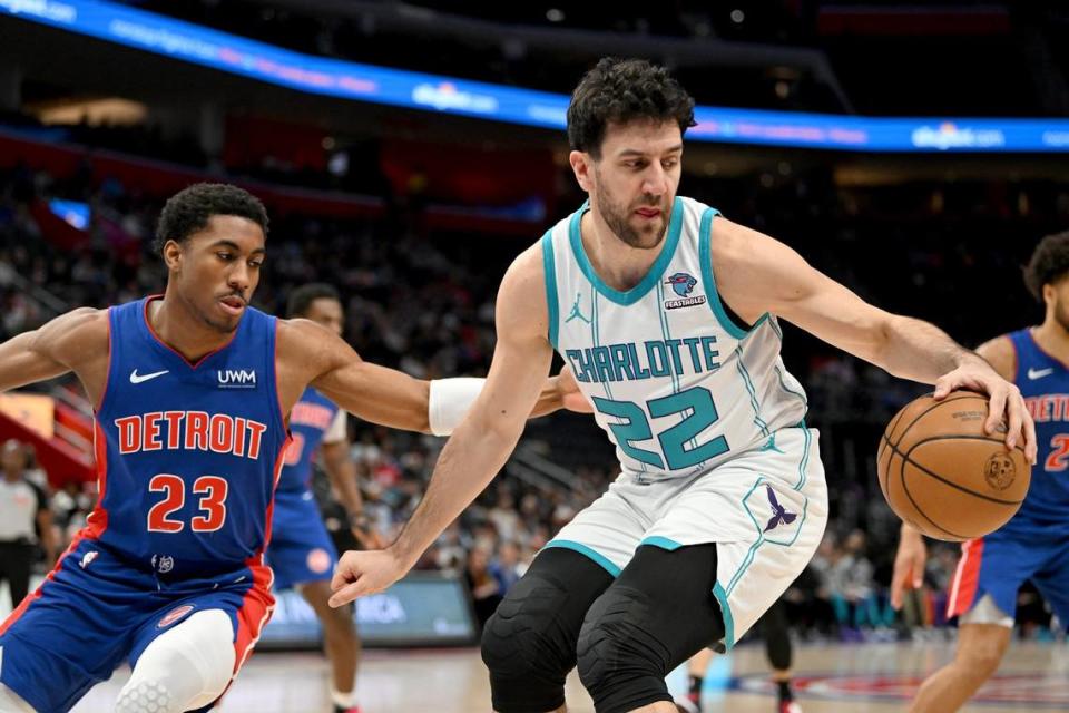 Charlotte Hornets guard Vasilije Micic (22) dribbles past Detroit Pistons guard Jaden Ivey (23) in the first quarter at Little Caesars Arena.