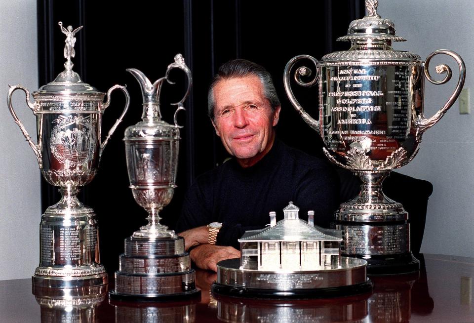 Gary Player poses in 2003 with his Grand Slam trophies at the offices of The Gary Player Group. From left, The U.S. Open Championship, The Open Championship, The Masters and The PGA Championship. Staff photo by Jennifer Podis.