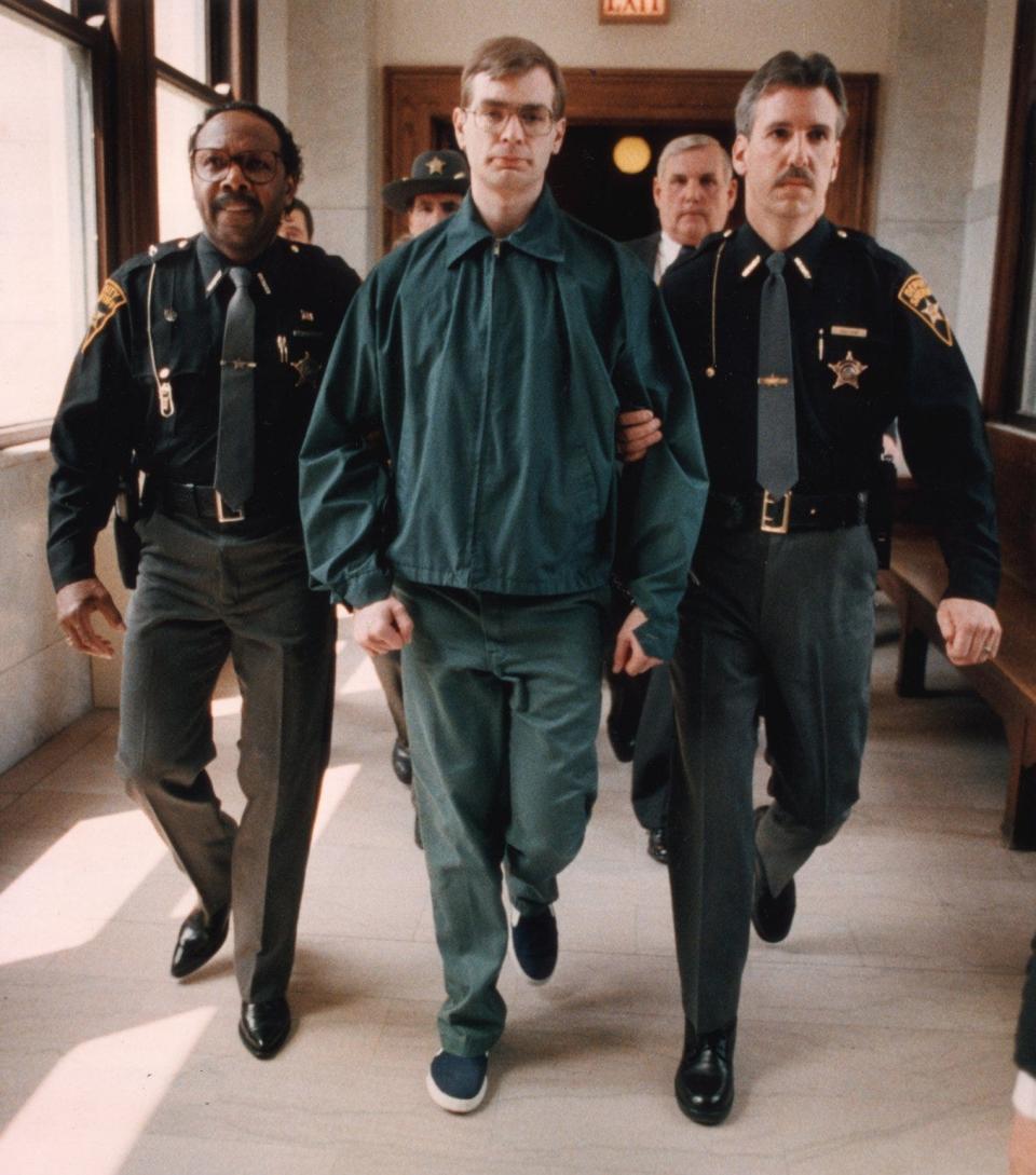 Convicted murderer Jeffrey Dahmer is led away from the Summit County Courthouse in Akron following a May 1, 1992, hearing in which he pleaded guilty to the murder of Steven Hicks in 1978.