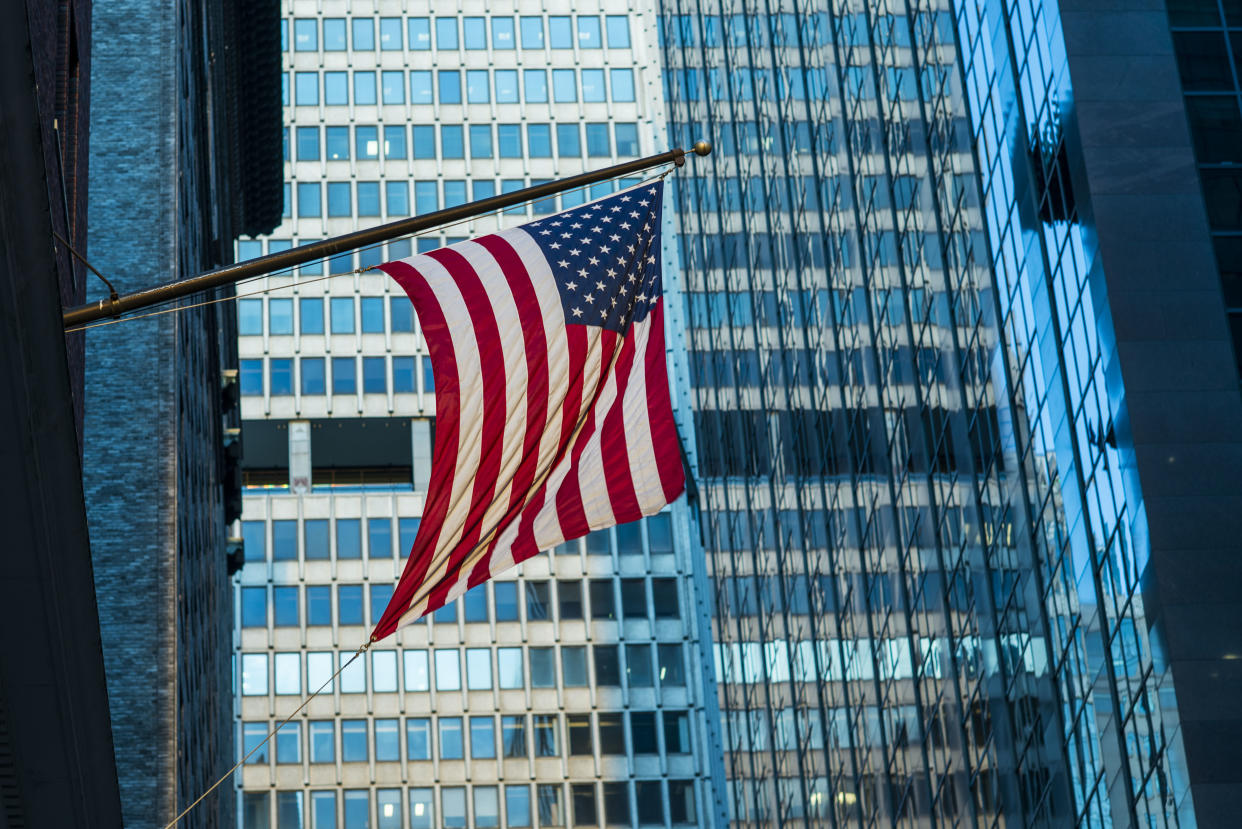 A US flag waves in Wall Street buildingon June 15 2012 in New York, United States of America. Photo by Victor Fraile (Photo by Victor Fraile/Corbis via Getty Images)