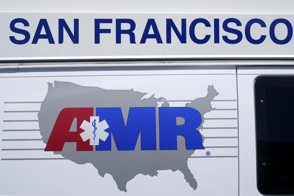 An AMR logo is pasted on the side of an American Medical Response vehicle in San Francisco, Monday, May 22, 2023. Lawyers sued medical transport provider American Medical Response West, saying the ambulance company's lax oversight allowed a paramedic to sexually assault two women in their 80s on their way to a hospital. (AP Photo/Jeff Chiu)