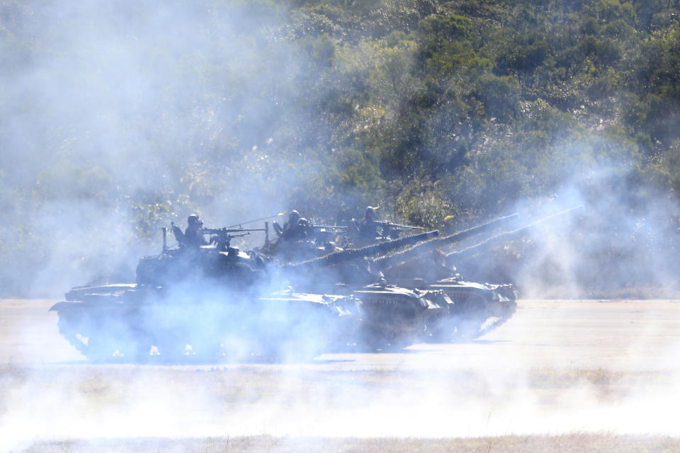 A line of Taiwan's tanks move during a military exercise in Hsinchu County, northern Taiwan, Tuesday, Jan. 19, 2021. Taiwanese troops using tanks, mortars and small arms staged a drill Tuesday aimed at repelling an attack from China, which has increased its threats to reclaim the island and its own displays of military might. (AP Photo/Chiang Ying-ying)