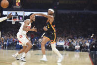 Oklahoma City Thunder guard Shai Gilgeous-Alexander, right, passes around Toronto Raptors forward Thaddeus Young, left, in the first half of an NBA basketball game, Sunday, Feb. 4, 2024, in Oklahoma City. (AP Photo/Kyle Phillips)