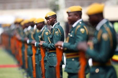 Military members stand guard before the arrival of Mugabe's coffin at the national sports stadium for a state funeral in Harare