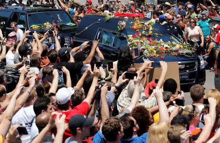 A hearse carrying the body of the late Muhammad Ali enters Cave Hill Cemetery in Louisville. REUTERS/John Sommers II