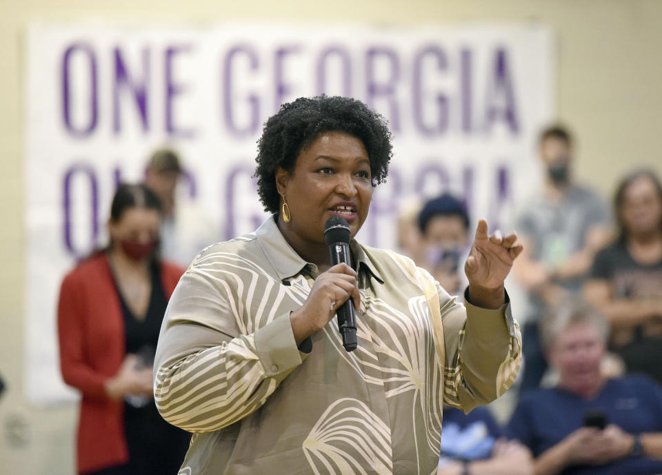 FILE - Georgia gubernatorial candidate Stacey Abrams answers questions from the crowd as she speaks during a visit to the Mack Gaston Community Center in Dalton, Ga., Friday, July 29, 2022. On Monday, Aug. 15, 2022, Abrams accused Republican Gov. Brian Kemp of trying to buy votes with a plan to make $350 payments to more than 3 million Georgians who benefit from Medicaid, subsidized child health insurance, food stamps or cash welfare. (Matt Hamilton/Chattanooga Times Free Press via AP, File)