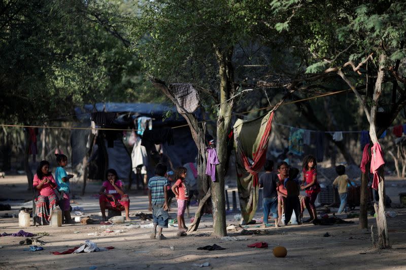 Women and children of the indigenous Wichi community are seen at a settlement, in the Salta province