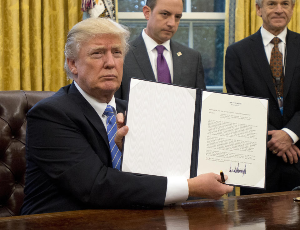 Trump holds an executive order titled "Mexico City Policy," which bans federal funds going to overseas organizations that perform abortions, on Jan. 23, 2017.