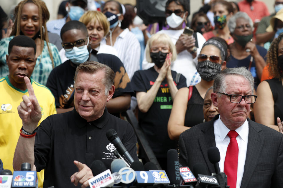 Father Michael Pfleger, left, speaks for first time after his reinstatement as the senior pastor at St. Sabina Church while his attorney Jim Figliulo listens during a press conference, Monday, May 24, 2021, at St. Sabina Catholic Church in the Auburn Gresham neighborhood in Chicago. (AP Photo/Shafkat Anowar)