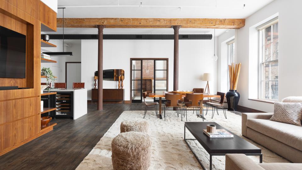 The air conditioning ductwork is painted black in this apartment to create a design feature