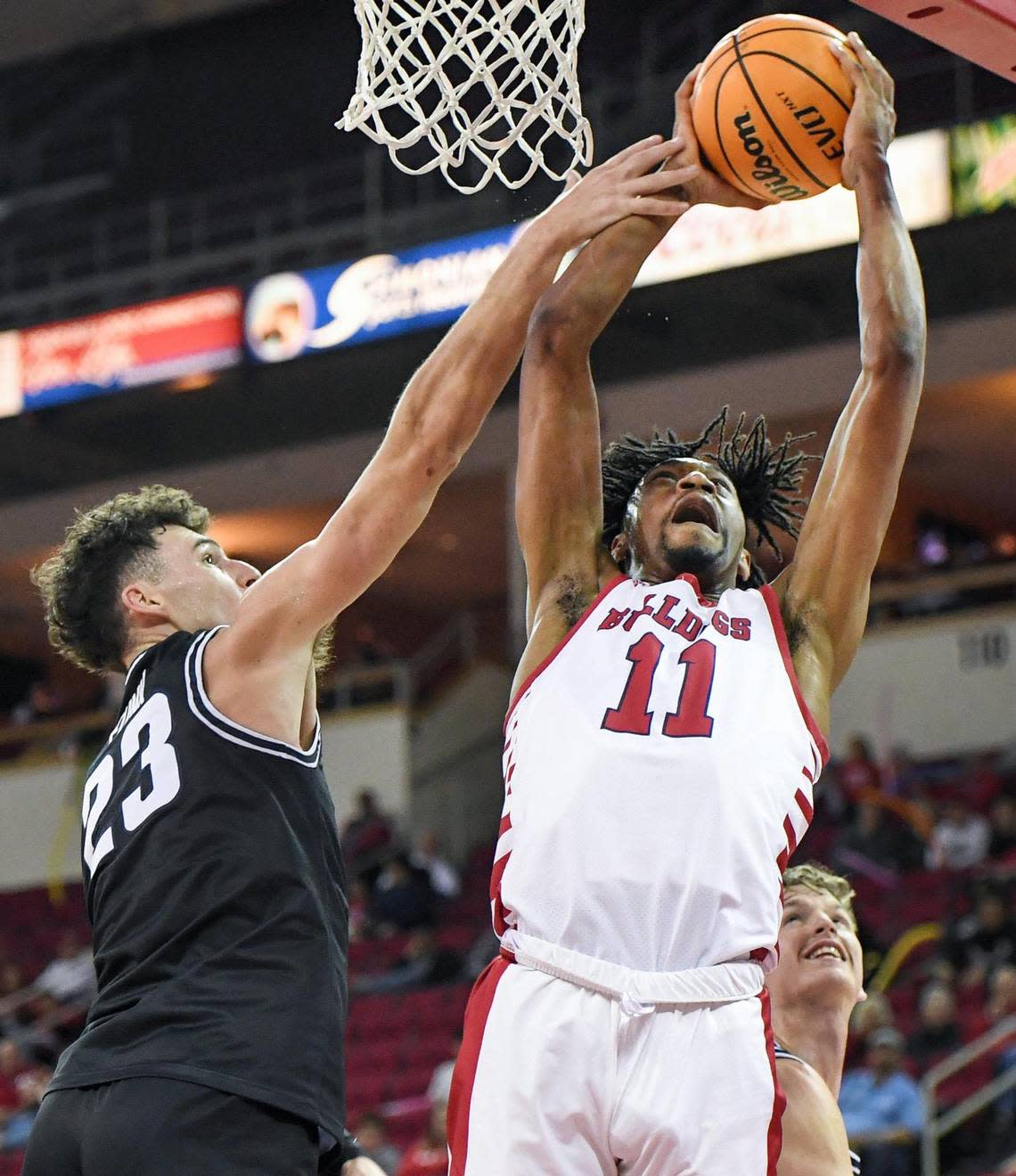 Fresno State’s Isaih Moore is fouled by Utah State’s Taylor Funk while going to the hoop during their Mountain West Conference game at the Save Mart Center in Fresno on Saturday, Jan. 28, 2023.