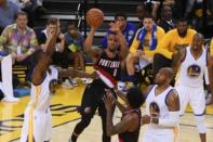 May 1, 2016; Oakland, CA, USA; Portland Trail Blazers guard Damian Lillard (0) passes the basketball against Golden State Warriors forward Harrison Barnes (40) during the fourth quarter in game one of the second round of the NBA Playoffs at Oracle Arena. Kyle Terada-USA TODAY Sports