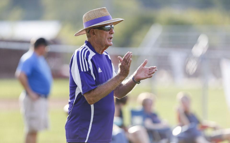 Bloomington South volunteer coach Scott Greer, known simply as Bones, encourages a Panther doubles team during a match against Greensburg on Oct. 2, 2018. Greer will watch South playing the regional from the sidelines tonight after retiring last spring. (Jeremy Hogan | Herald-Times)