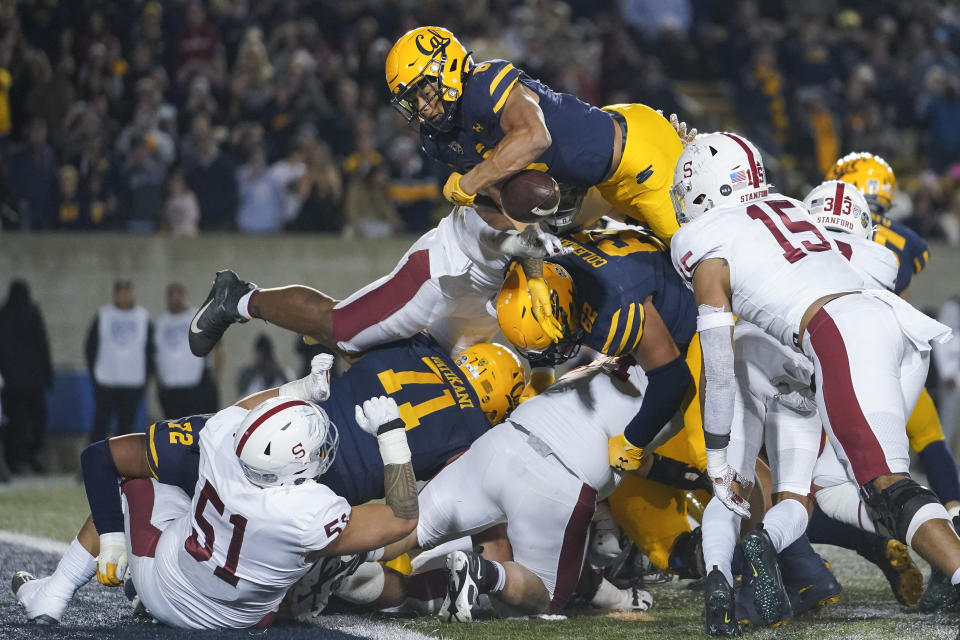 California running back Jaydn Ott, top, fumbles the ball while attempting to dive into the end zone against Stanford during the second half of an NCAA college football game in Berkeley, Calif., Saturday, Nov. 19, 2022. California recovered the ball. (AP Photo/Godofredo A. Vásquez)