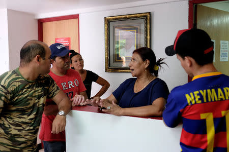 Lilia Gonzales (C), a staff member of the Caritas shelter for migrants, explains the center policy and options to new Cuban migrants that arrived the previous night to the center in Panama City, Panama, January 13, 2017. REUTERS/Melchor Herrera