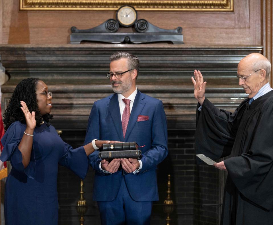 Supreme Court Justice Stephen Breyer administers the judicial oath to Ketanji Brown Jackson while her husband, Patrick Jackson, holds the Bible on June 30, 2022.