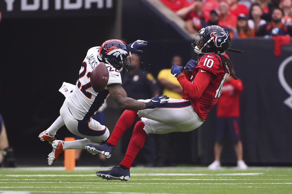 Denver Broncos strong safety Kareem Jackson (22) breaks up a pass intended for Houston Texans wide receiver DeAndre Hopkins (10) during the first half of an NFL football game Sunday, Dec. 8, 2019, in Houston. (AP Photo/Eric Christian Smith)