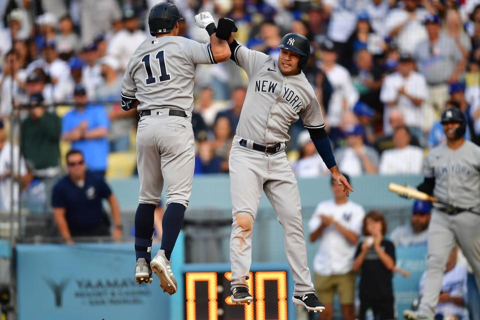 Yankees shortstop Anthony Volpe, left, is greeted by center fielder Isiah Kiner-Falefa after hitting a two-run homer in the ninth inning of Sunday's 4-1 win over the Dodgers.