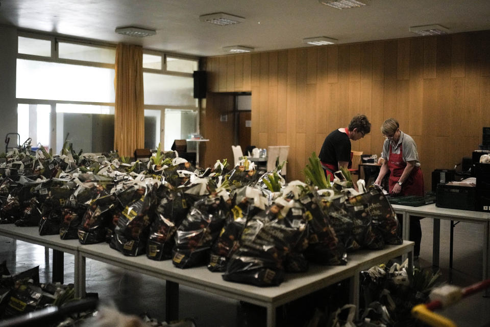 Women prepare bags with groceries for delivery, at a food distribution center at the Catholic St. William Church in Berlin, Germany, Wednesday, May 31, 2023. German inflation eased to 6.1% in May following several months of declines, even as Europe's biggest economy registered another painful increase in food prices of nearly 15%. (AP Photo/Markus Schreiber)